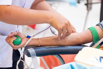 Healthcare professional assisting a donor during blood donation. Symbol of compassion, medical...