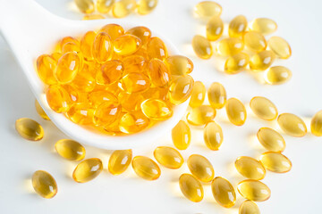 Fish oil or Cod liver oil gel in capsules with omega 3 vitamins, supplementary healthy food.