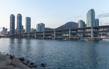 Modern Cityscape with Bridge and Tall Skyscrapers by a Calm Blue Waters