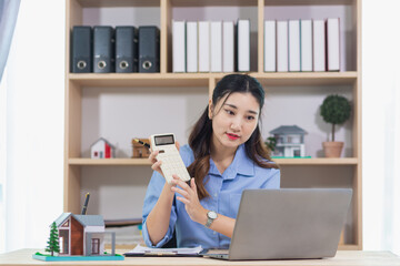 Real estate businessman or broker is calculating interest rate based on the period of time that the client wants to use in deciding to make a contract to buy a real estate. Real estate trading concept