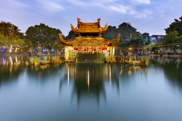 Scenic view of Thay Pagoda near Hanoi, Vietnam, surrounded by lkudsh greenery and tranquil waters