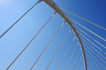 Fototapeta premium Abstract View of Suspension Bridge Cables Against Blue Sky