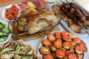 table setting for a festive dinner, grilled duck and appetizers
