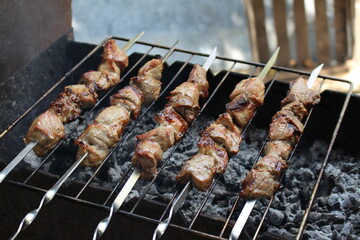 a man grills meat for his family