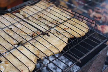 cooking barbecue outdoors on a grill