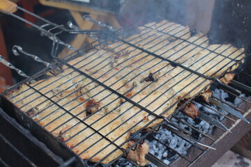 cooking barbecue outdoors on a grill
