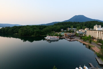 Fototapeta premium Tranquil Lakeside View of Lake Akan with Mount Oakan in Hokkaido, Japan