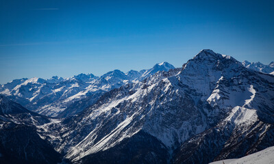 Snow-covered forest nestled in winter mountains, with frosted trees and peaceful trails. A serene and crisp landscape perfect for nature lovers, hiking, and winter outdoor adventures.
