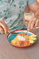 A Deliciously Plated Meal Featuring Avocado, Salmon, and Creamy Sauce Served on a Colorful Dish, Perfect for a Luxurious Breakfast or Brunch Experience