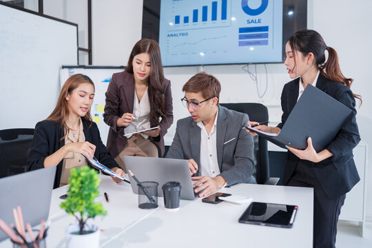 Group of Asian business people meeting and presenting work in the office

