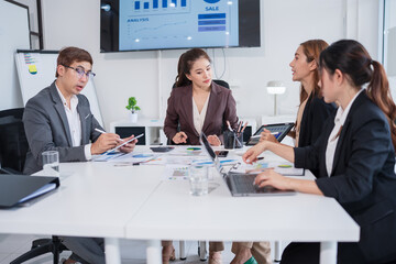 Group of Asian business people meeting and presenting work in the office
