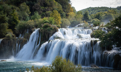Peaceful waterfall in a Croatian national park surrounded by lush greenery and clear water. A stunning natural landscape ideal for travel, nature, adventure, and outdoor-themed content.