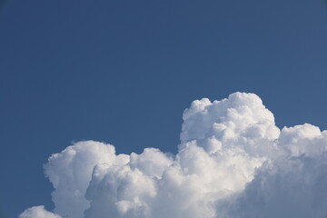 Bright blue sky with fluffy white cumulus clouds
