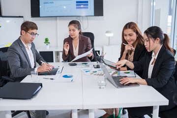 Group of Asian business people meeting and presenting work in the office