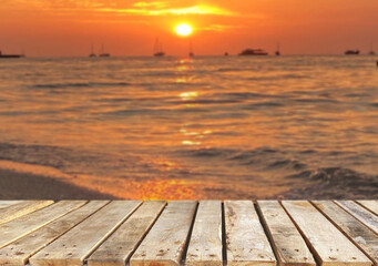 Wooden table top on the beach or sea.Party on the beach  sunset time concept.For montage product display or design key visual layout.View of copy space.