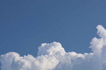 Bright blue sky with fluffy white cumulus clouds
