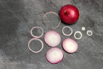 Sliced red onion on grey background. Top view, copy space