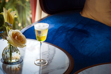 a clear sparkling golden cocktail liquor in Cordial glass serving in evening bar