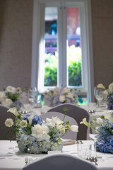 wedding reception dinner table suit set up with decoration flower before evening event start in the hall
