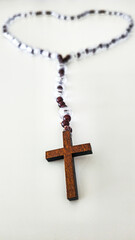 Rosary with Wooden Cross – Symbol of Faith on White Background