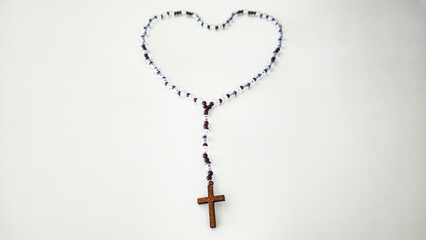 Rosary with Wooden Cross – Symbol of Faith on White Background