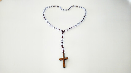 Rosary with Wooden Cross – Symbol of Faith on White Background