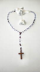 Rosary with Wooden Cross – Symbol of Faith on White Background