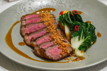 pack of sliced beef steak in dish with appetized vegetable