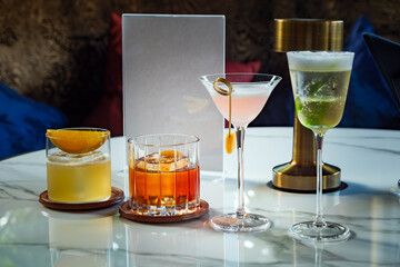 many type of cocktail and glass type on white marble table in the bar