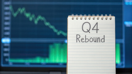Q4 rebound concept with notebook in front of stock market graph Q4 Rebound