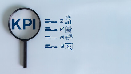 Magnifying glass focusing on KPI letters with business checklist and performance icons on a blue background. Concept of KPI analysis, planning, and result tracking.