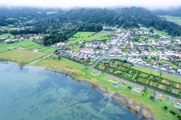 A Rural Town with Green Hills and a Calm Lake. Concept The peace and tranquility of the...
