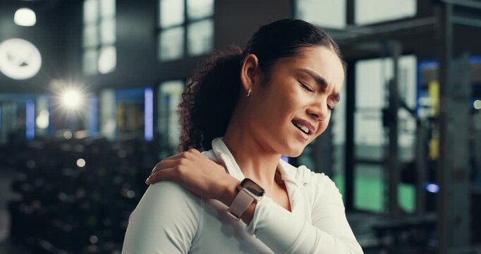 Fitness, woman and shoulder pain in gym, hurt or sore with training accident, massage and fractured. Injury, person and muscle strain in health club, discomfort and joint tension or broken bone