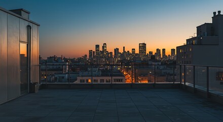Fototapeta premium A tranquil rooftop terrace at sunset, offering a stunning view of a distant cityscape as the sky transitions from orange to blue.