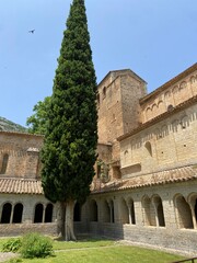 Gellone abbey seen from the cloister with cypress tree,  Saint-Guilhem-le-Désert 