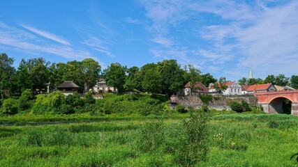 Picturesque Riverside Village with Historic Red Brick Bridge. The Venta River in Kuldiga, Latvia.