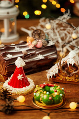 Christmas cakes displayed on wooden table with festive decorations
