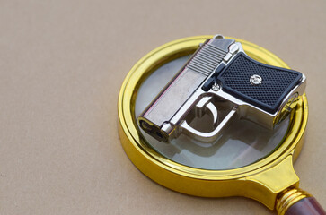 Crime Scene Evidence: Pistol on Magnifying Glass Depicting Forensic Investigation Process
