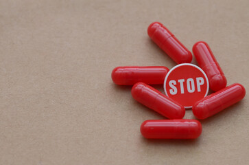 "STOP" Sign Surrounded by Red Capsules: Visual Warning Against Medication Misuse