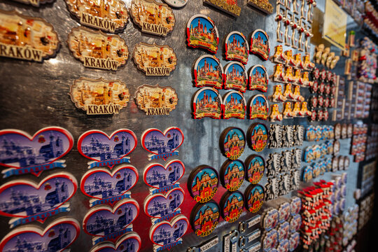 Colorful fridge magnets featuring landmarks of Krakow, Poland displayed on a metal board
