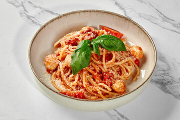 Delicious italian spaghetti with tomato sauce, meatballs and basil leaves