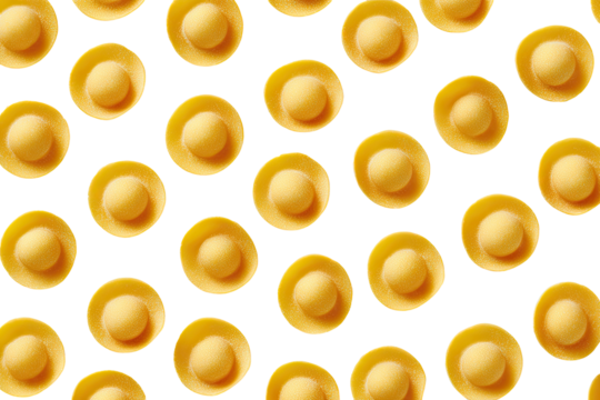 Close-up of small, pale yellow pasta, in a repeating pattern against black