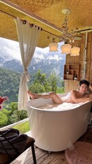 Handsome Man Relaxing in Bubble Bath on Veranda Amidst Lush Green Forest and Gentle Rain