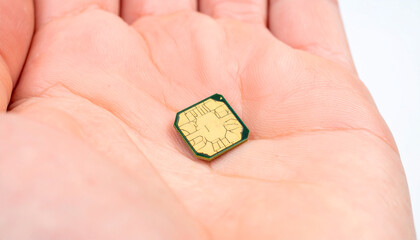 Fototapeta premium SIM Card in Palm: A close-up shot showcases a SIM card resting delicately in the open palm of a hand, symbolizing connection and communication in the digital world.