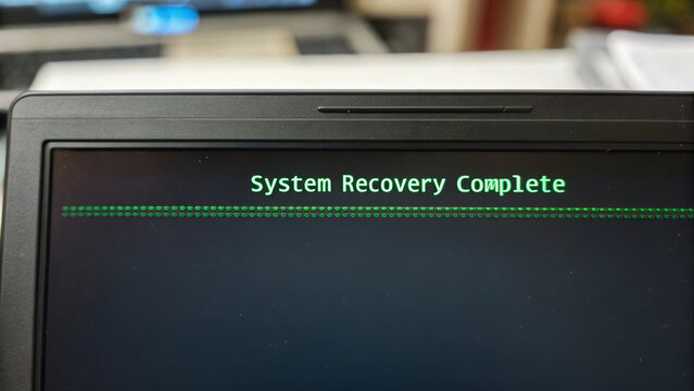 System recovery complete message on computer screen signifies successful business data restoration. Business Recovery