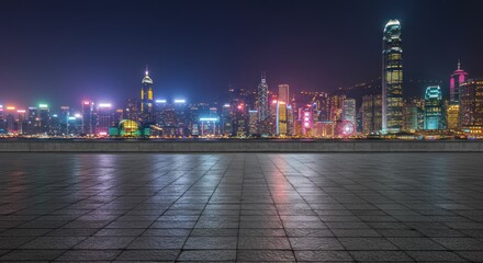 Nighttime cityscape view showcasing illuminated skyscrapers and reflecting pavement.