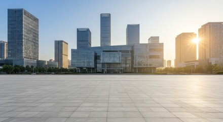 Empty plaza in front of modern skyscrapers, bathed in morning sunlight.
