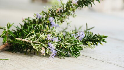 Rosemary with Flowers on Table – Aromatic Herbal Close-Up.