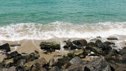 The foam of sea waves crashes on the rocks at Dhanushkodi beach in Tamil Nadu, India