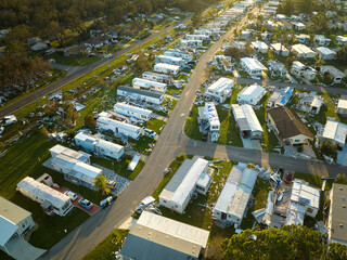 Severely damaged by hurricane Ian houses in Florida mobile home residential area. Consequences of...